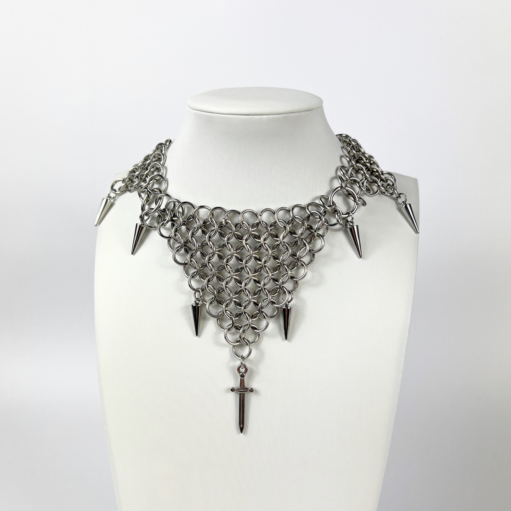 bold chainmail statement choker, with triangle parts, spikes, and dagger, silver tone stainless steel, corporate goth alt medieval fantasy style, necklace for women