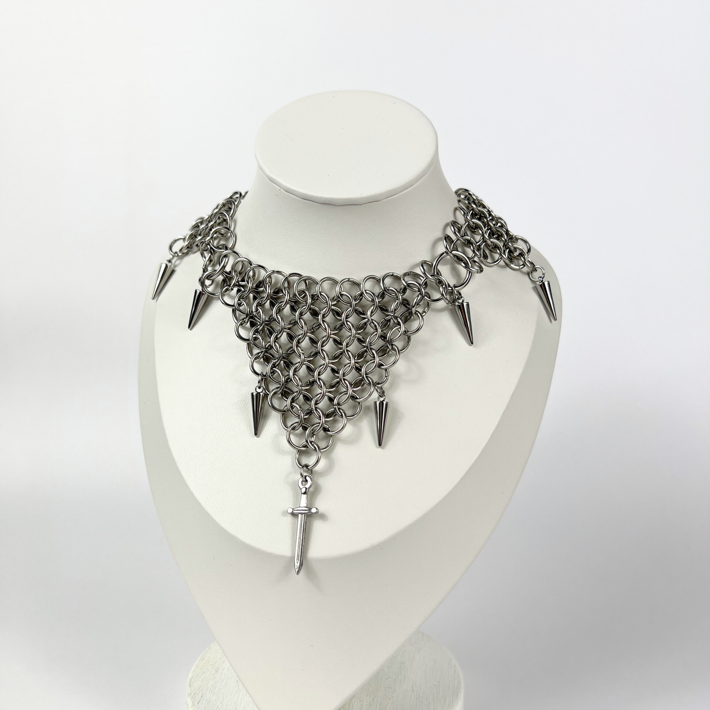 bold chainmail statement choker, with triangle parts, spikes, and dagger, silver tone stainless steel, corporate goth alt medieval fantasy style, necklace for women