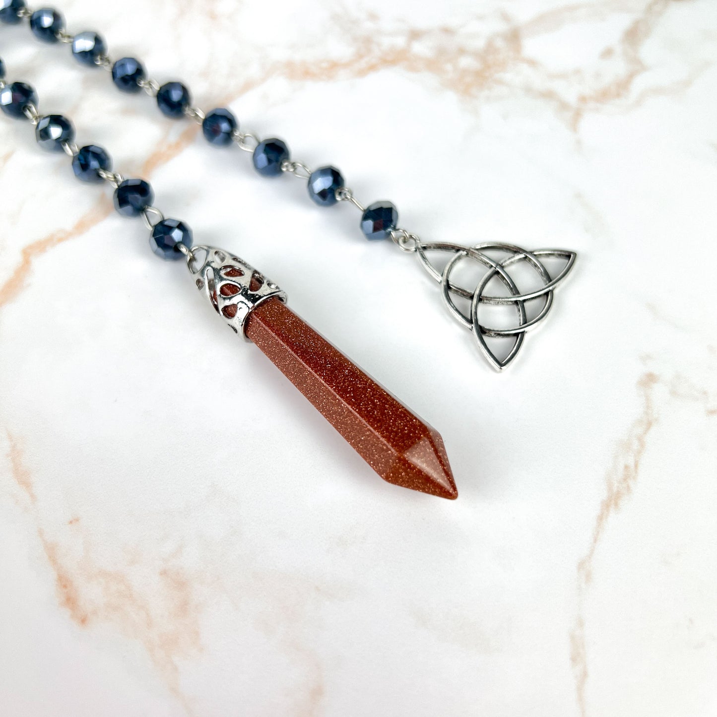 Goldstone pendulum, rosary chain and triquetra charm