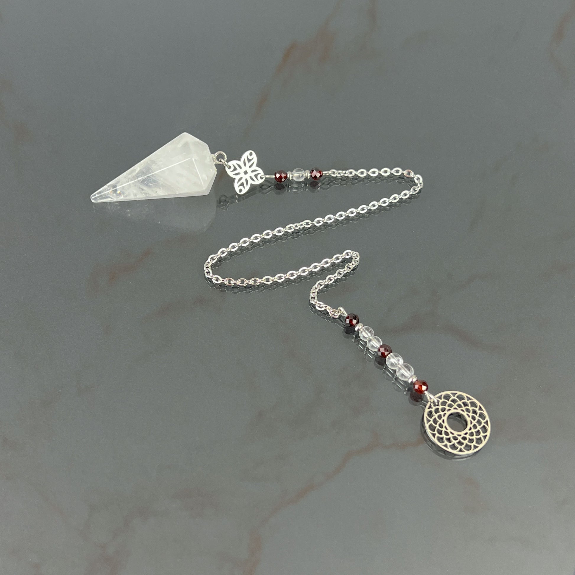 Quartz, garnet and stainless steel sacred geometry pendulum Baguette Magick