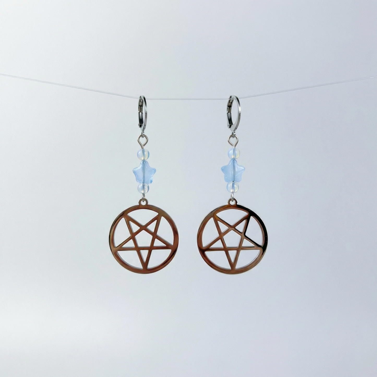 Inverted pentacle pastel goth earrings, with blue stars and opalite