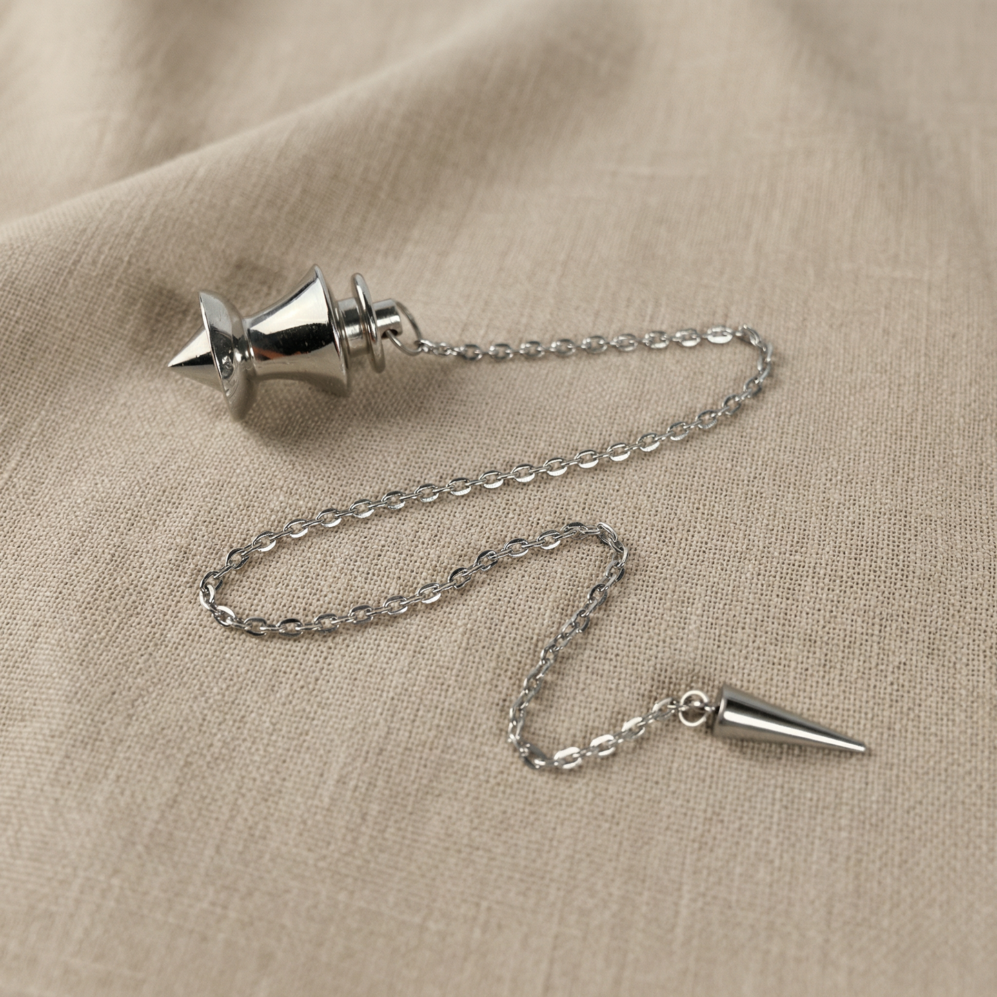 Point and dome dowsing metal pendulum with a spike charm