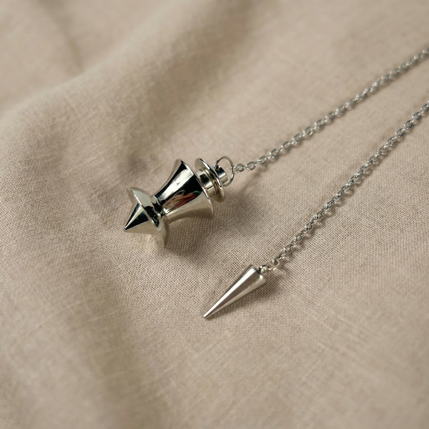 Point and dome dowsing metal pendulum with a spike charm