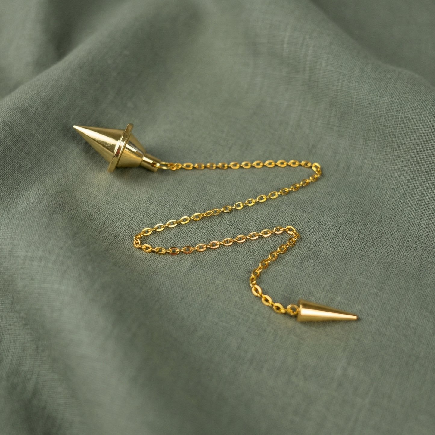Golden double cone pendulum with a spike charm