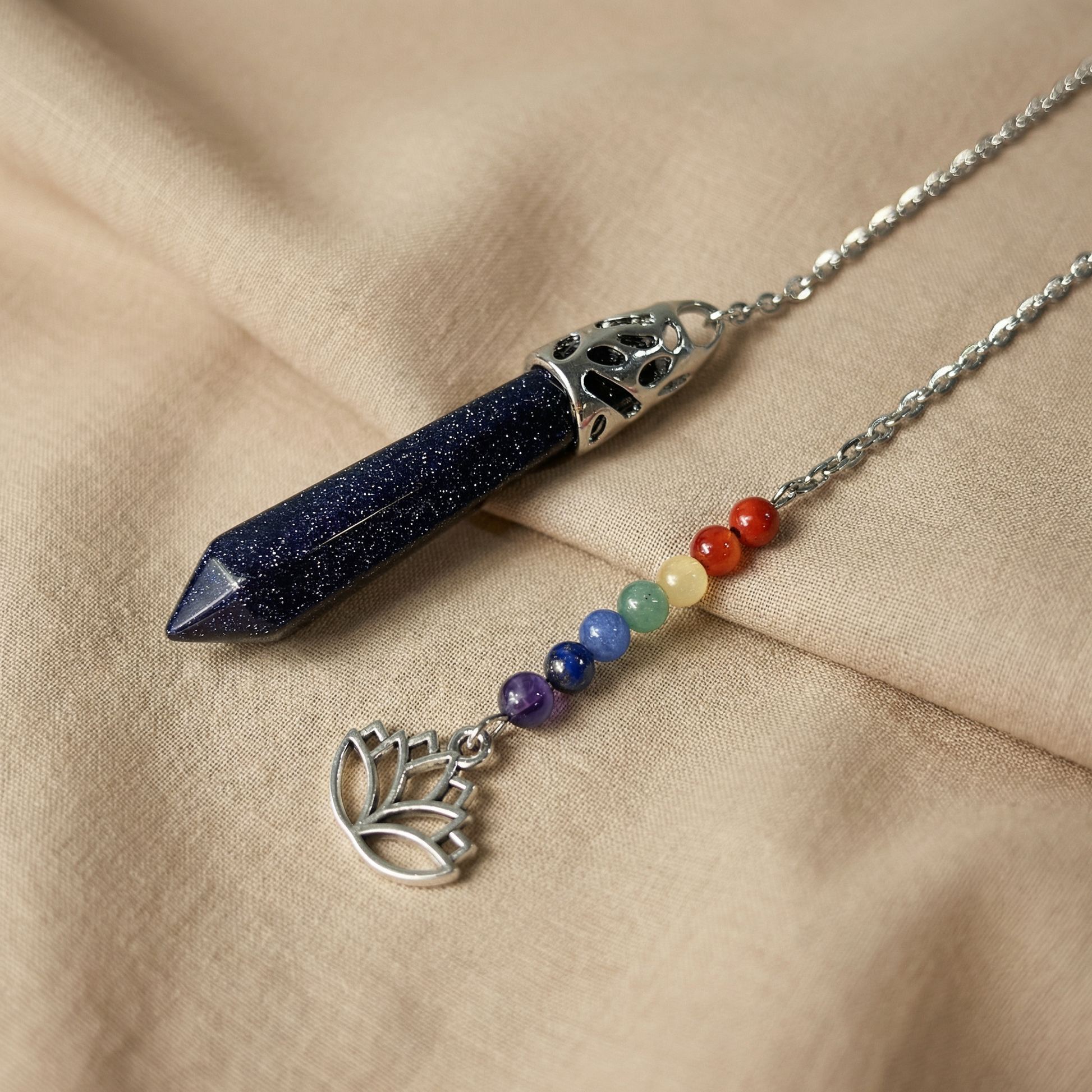 7 chakras blue sandstone pendulum with a lotus charm Baguette Magick