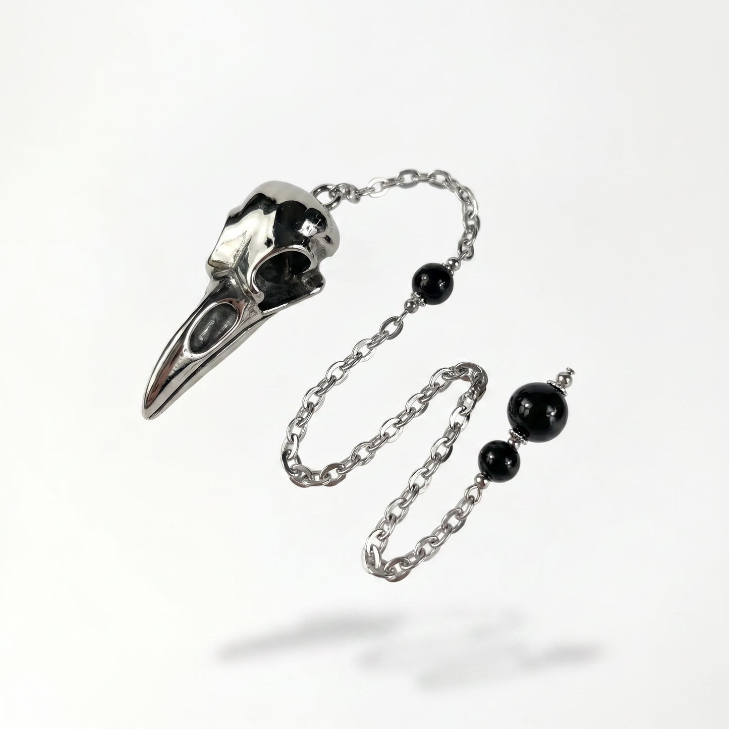 Pendule de radiesthésie en acier inoxydable avec crâne de corbeau et obsidienne