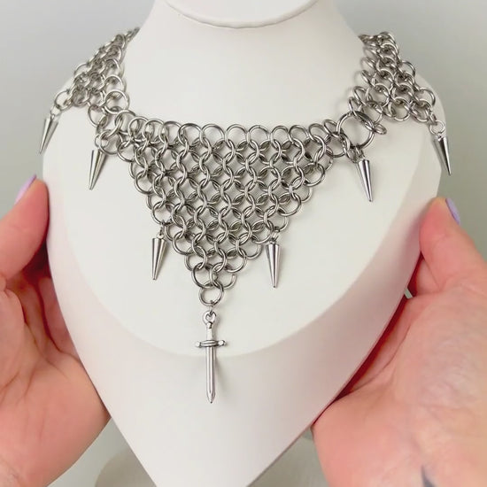 bold chainmail statement choker, with triangle parts, spikes, and dagger, silver tone stainless steel, corporate goth alt medieval fantasy style, necklace for women