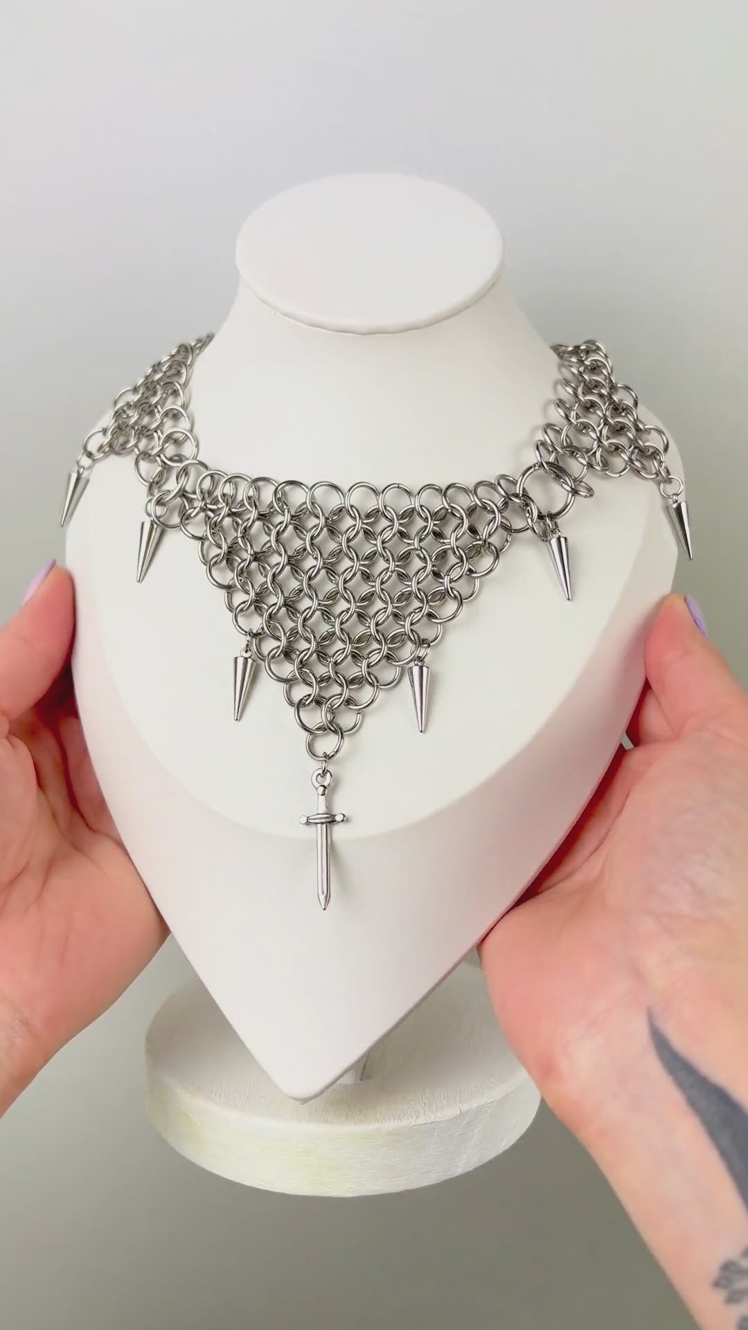 bold chainmail statement choker, with triangle parts, spikes, and dagger, silver tone stainless steel, corporate goth alt medieval fantasy style, necklace for women