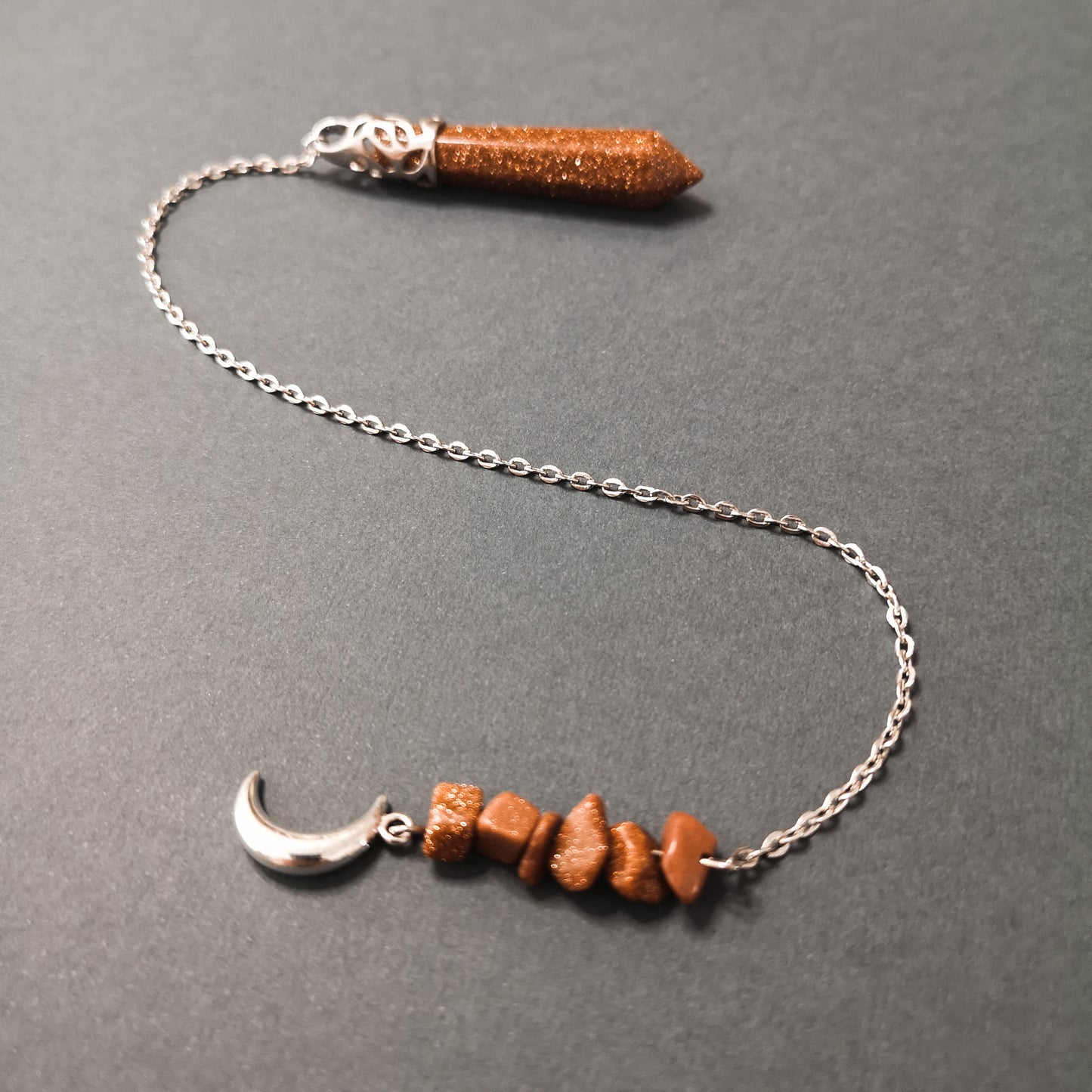 Goldstone pendulum with a crescent moon