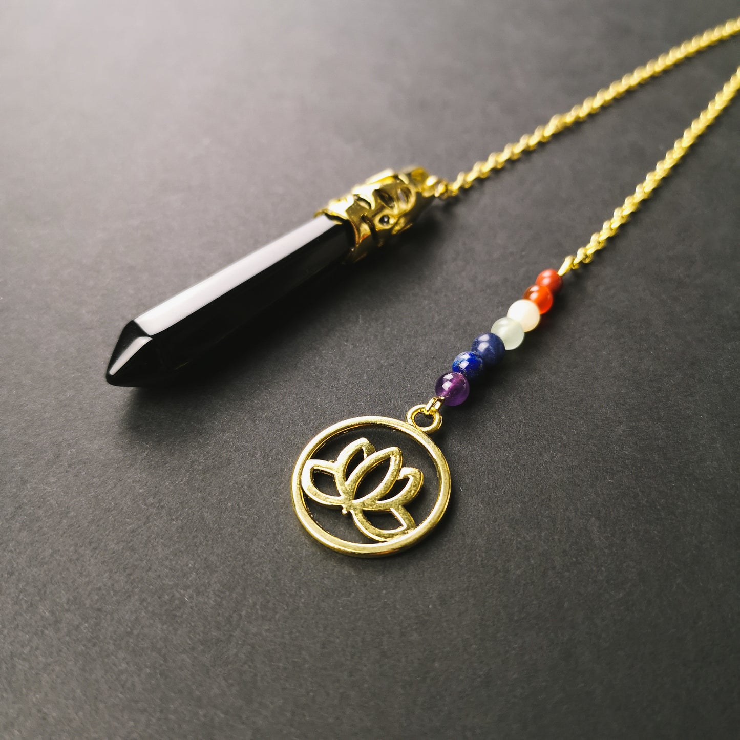 Golden onyx and seven chakras stones pendulum with a lotus charm - The French Witch shop
