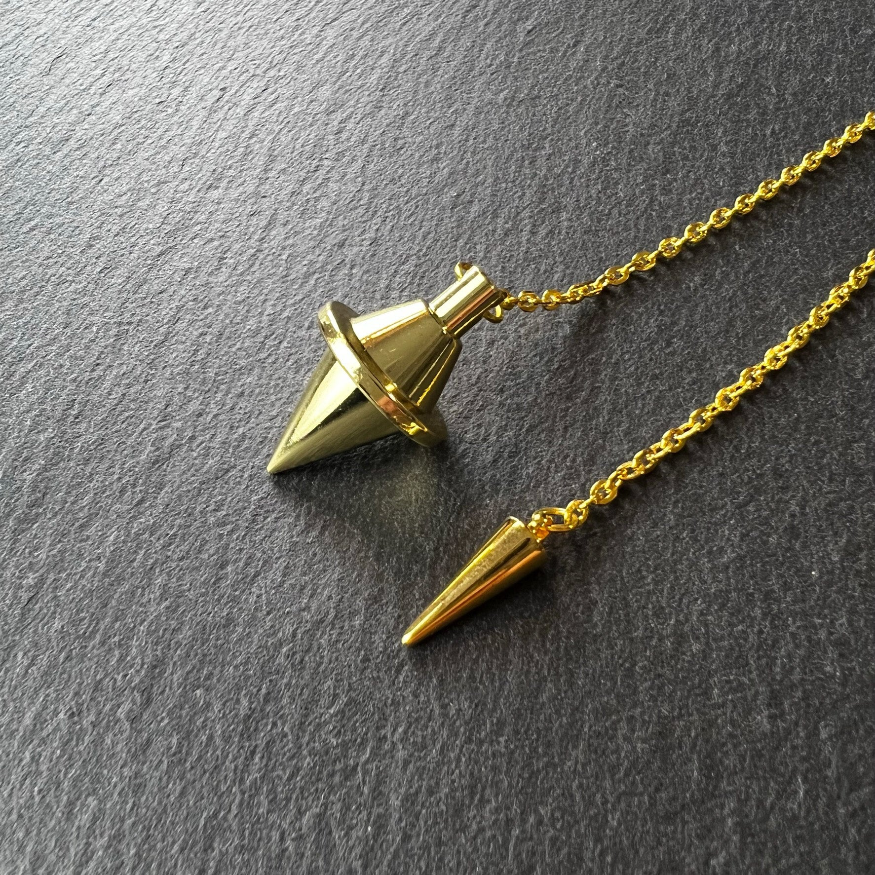 Golden double cone pendulum with a spike charm Baguette Magick
