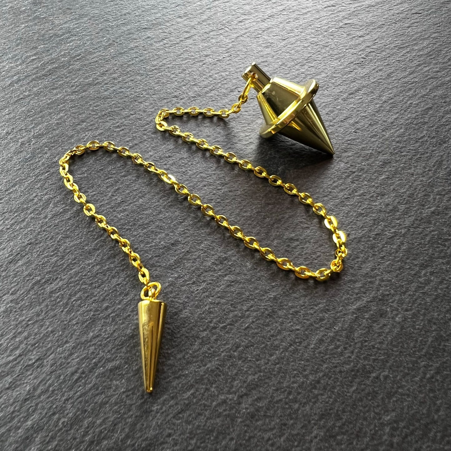 Golden double cone pendulum with a spike charm Baguette Magick
