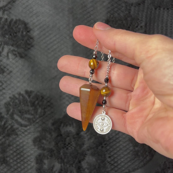 Gemstone pendulum tiger eye, faceted onyx and stainless steel with a third eye and stars charm dowsing divination tool